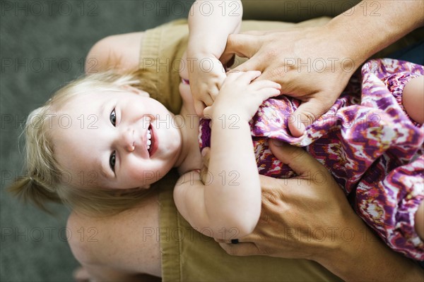 Father playing with baby girl (12-17 months)