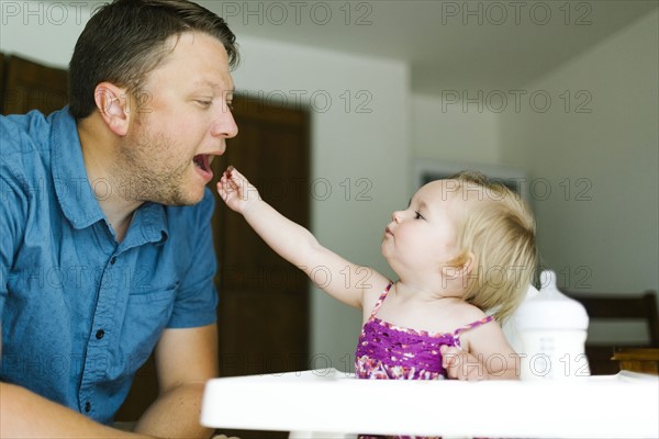 Father playing with baby girl (12-17 months)