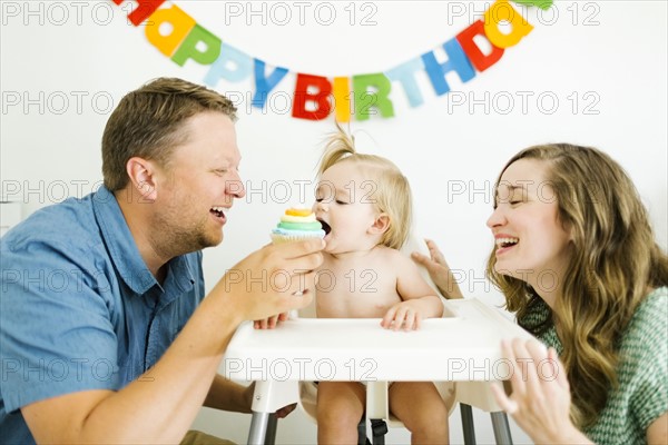 Mother and father celebrating first birthday of daughter (12-17 months)