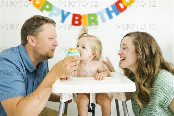 Mother and father celebrating first birthday of daughter (12-17 months)