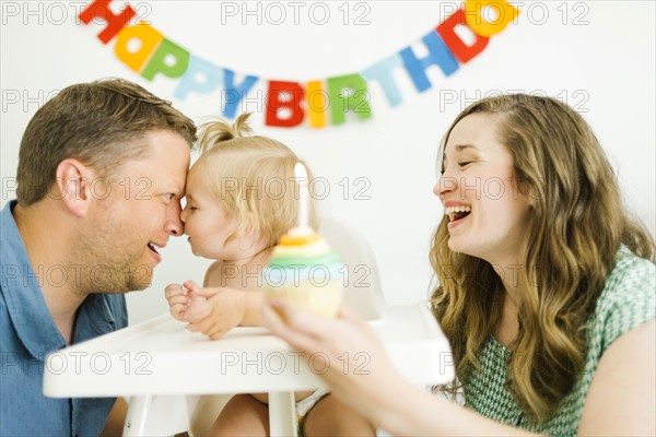 Mother and father celebrating first birthday of daughter (12-17 months)