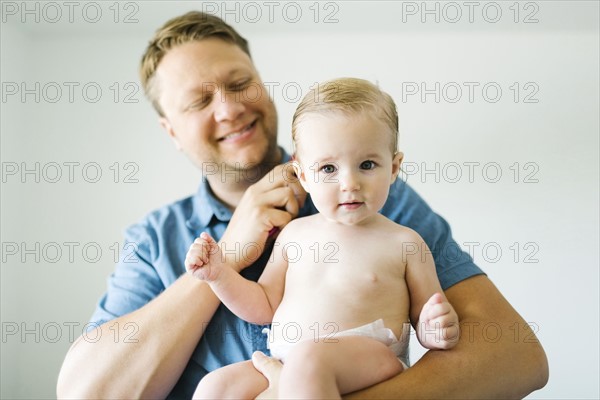 Portrait of father and baby girl (12-17 months) after bath