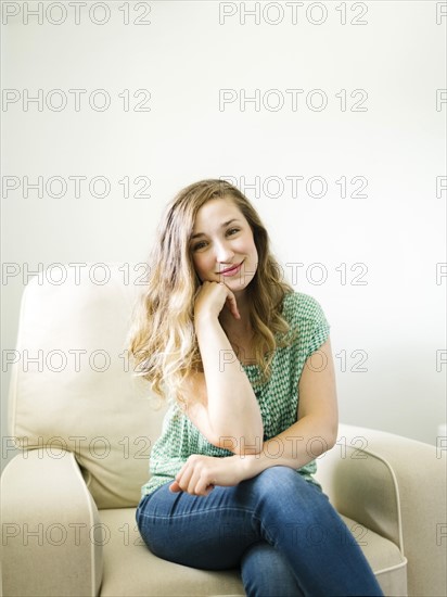 Portrait of woman sitting in living room