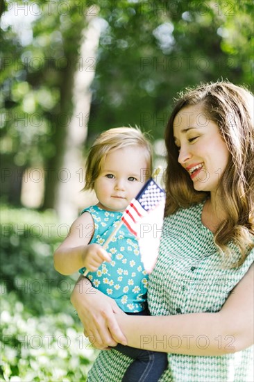 Portrait of mother and baby girl (12-17 months) in backyard