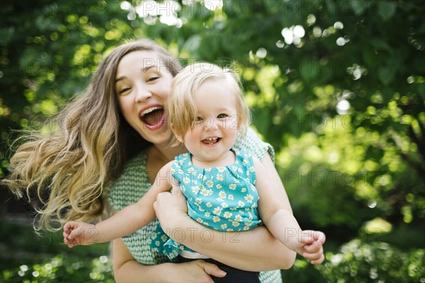 Portrait of mother carrying daughter (12-17 months)