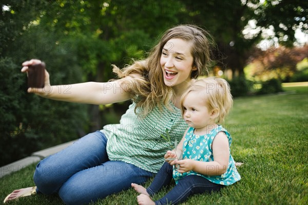 Mother taking selfie with daughter (12-17 months)