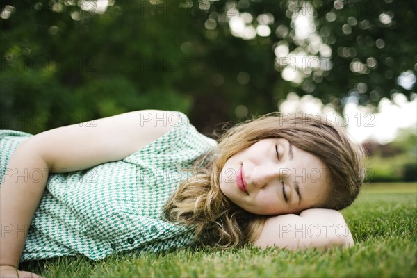 Woman lying on grass and sleeping