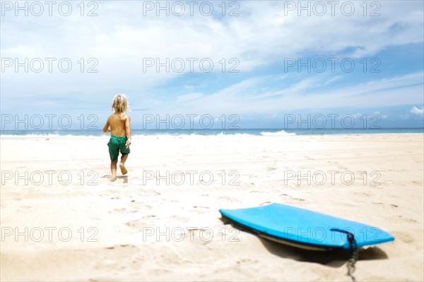 Boy running on beach