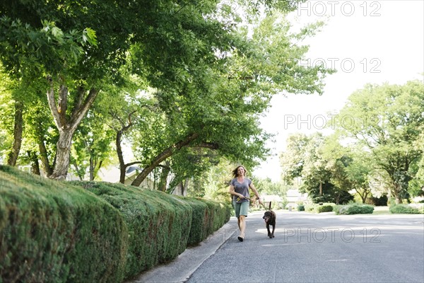 Woman walking with Labrador Retriever