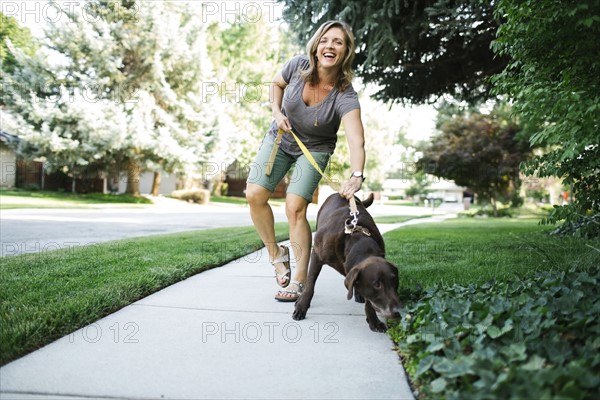 Woman walking with Labrador Retriever