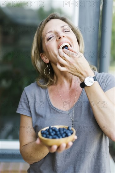 Woman eating blueberries