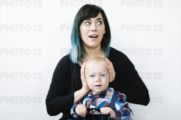 Mother covering son's ears (12-17 months)