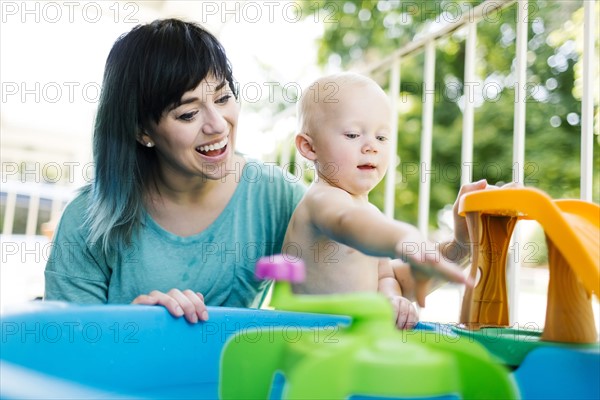 Mother with baby boy (12-17 months) playing with inflatable toys