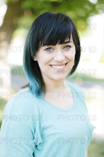 Portrait of smiling woman with blue ombre hair
