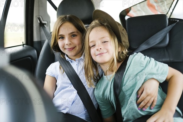 Brother (6-7) and sister ( 8-9) sitting in car