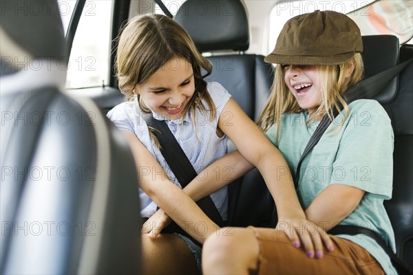 Brother (6-7) and sister ( 8-9) playing in car