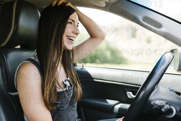 Smiling woman driving car