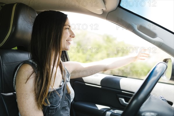 Smiling woman driving car