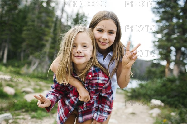 Outdoor portrait of brother (6-7) and sister ( 8-9) in forest