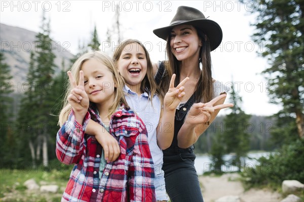 Outdoor portrait of mother with kids (6-7, 8-9) in forest