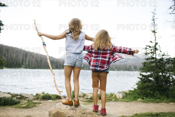 USA, Utah, Midway, Brother (6-7) and sister ( 8-9) standing by lake in forest