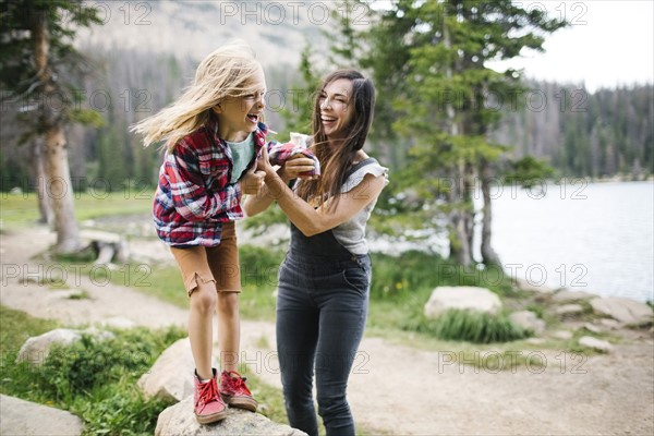 USA, Utah, Midway, Mother playing with son (6-7) by lake in forest