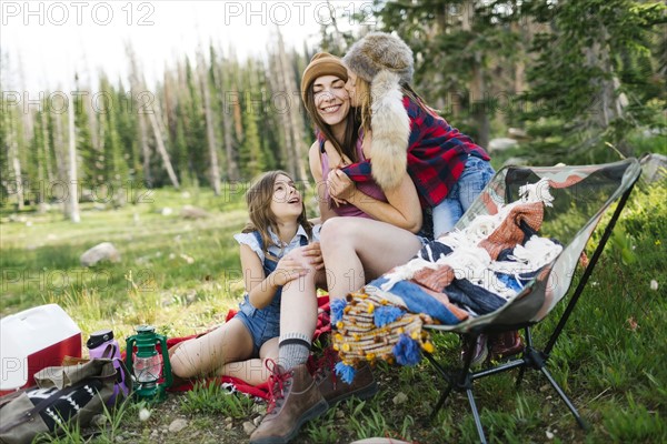 Mother with son (6-7) and daughter (8-9) camping in forest