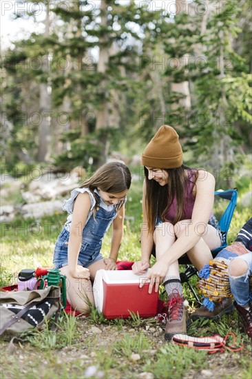 Mother with daughter (8-9) camping in forest