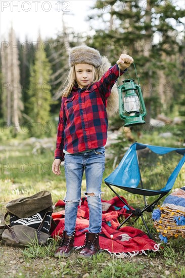 Portrait of boy (6-7) with camping gear in forest