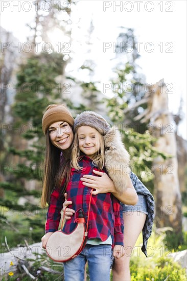 Portrait of mother with son (6-7) hiking in forest