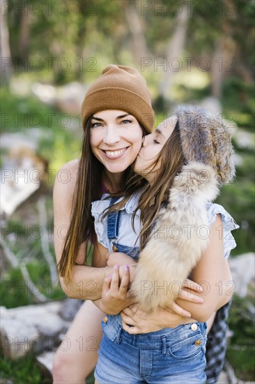 Portrait of mother with daughter (8-9) hiking in forest