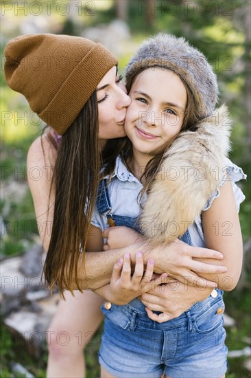 Portrait of mother with daughter (8-9) hiking in forest