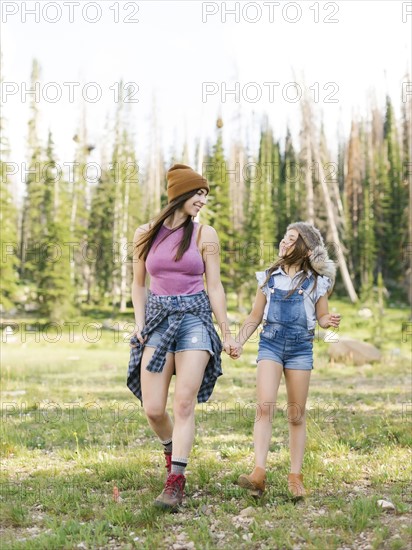 Mother with daughter (8-9) hiking in forest
