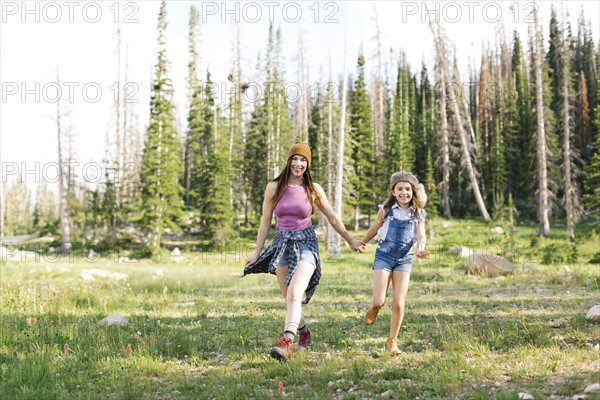 Mother with daughter (8-9) hiking in forest