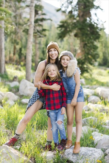 Portrait of mother with son (6-7) and daughter (8-9) hiking in forest