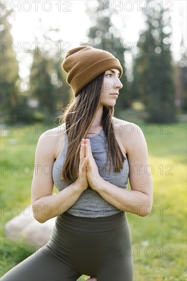 Woman practicing yoga in forest