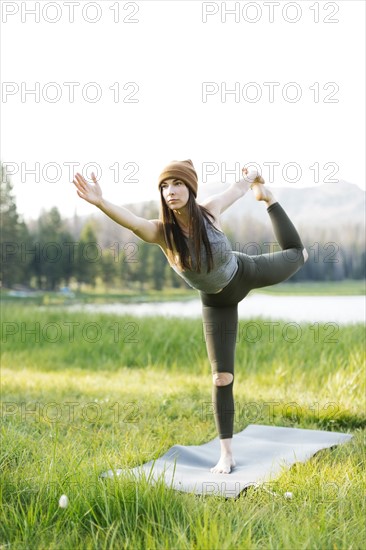 Woman practicing yoga in forest