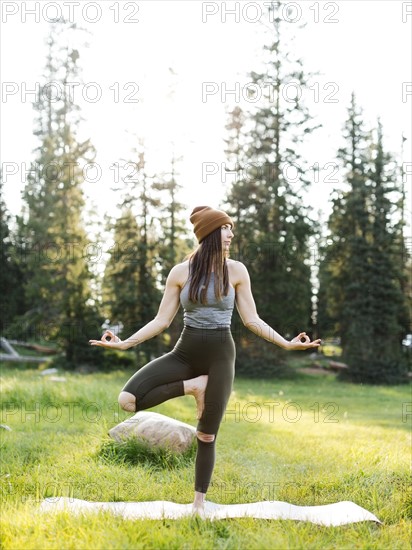 Woman practicing yoga in forest