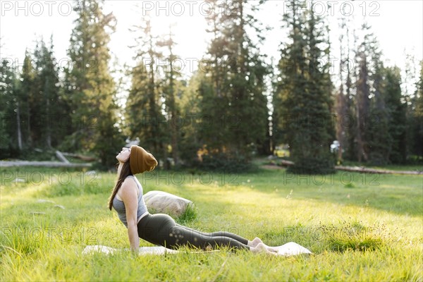 Woman practicing yoga in forest