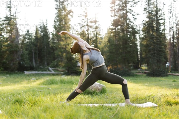 Woman practicing yoga in forest