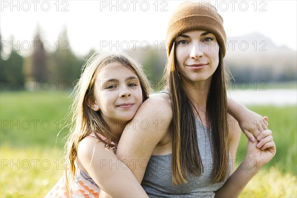 Portrait of mother and daughter (8-9) in meadow