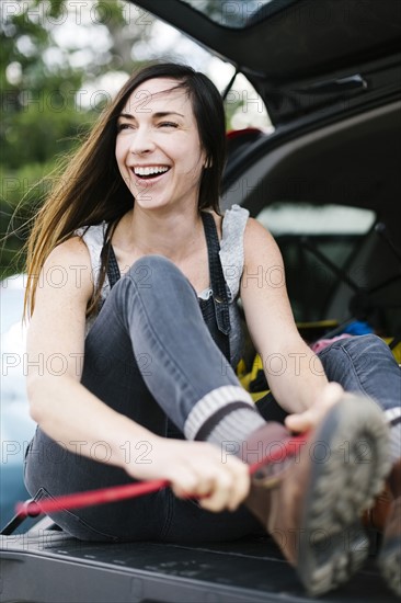 Woman tying hiking boot