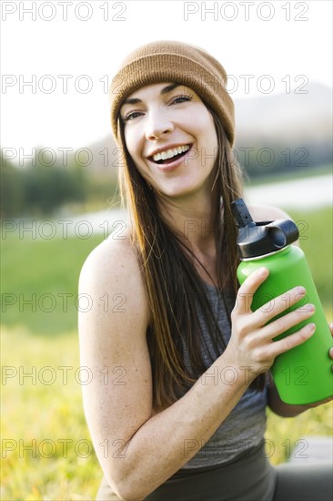 Portrait of woman holding water bottle