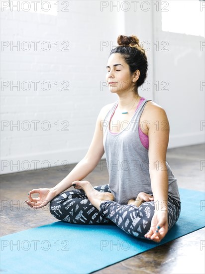 Woman meditating in lotus position