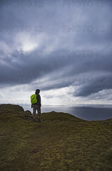 Ireland, County Donegal, Hiker looking at Donegal bay along Wild Atlantic Way