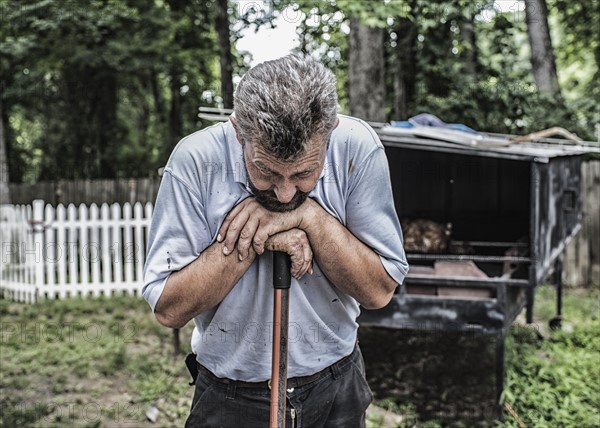 Man working by traditional Bosnian cook hut in backyard