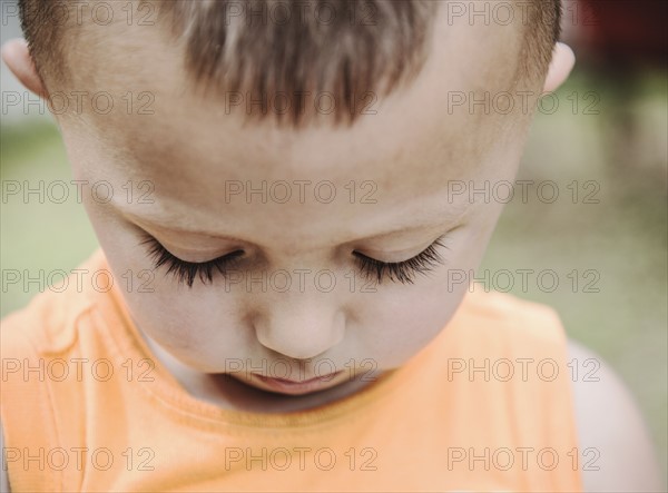 Boy (2-3) looking down