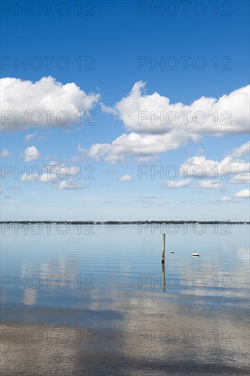 Clouds reflecting in water on sunny day