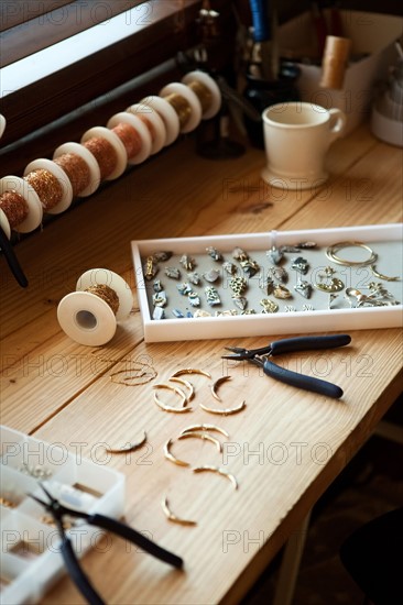 Tools and jewelry on table