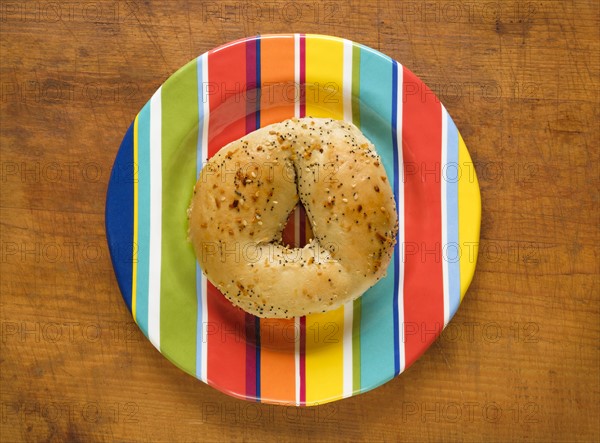 Bagel on colorful plate